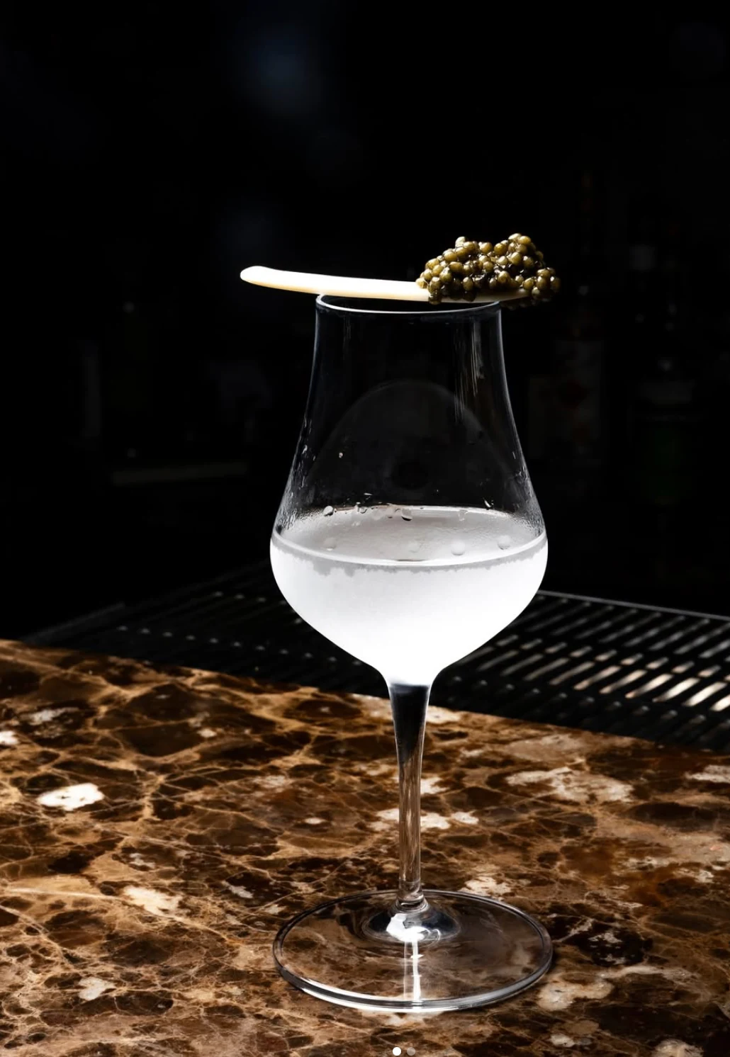 Cocktail served with a spoon of caviar