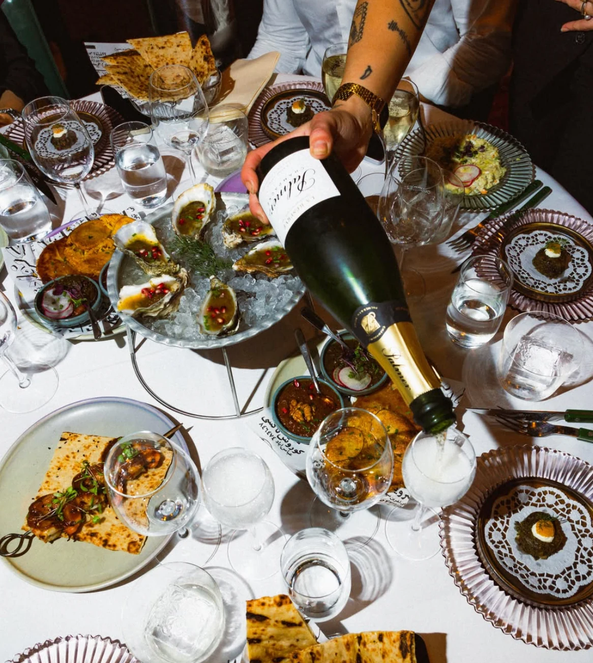 Persian dishes, oysters and champagne around the table